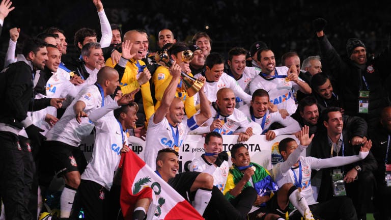 Corinthians players celebrate their win with the champions board after the FIFA Club World Cup Final