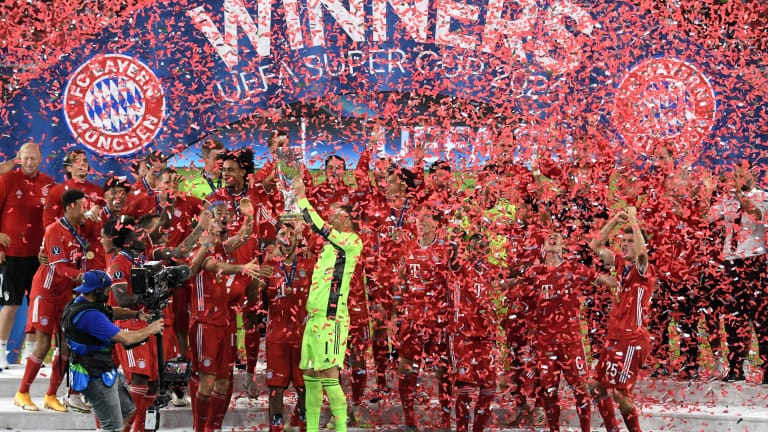 Manuel Neuer of Bayern Munich lifts the UEFA Super Cup trophy as he celebrates victory