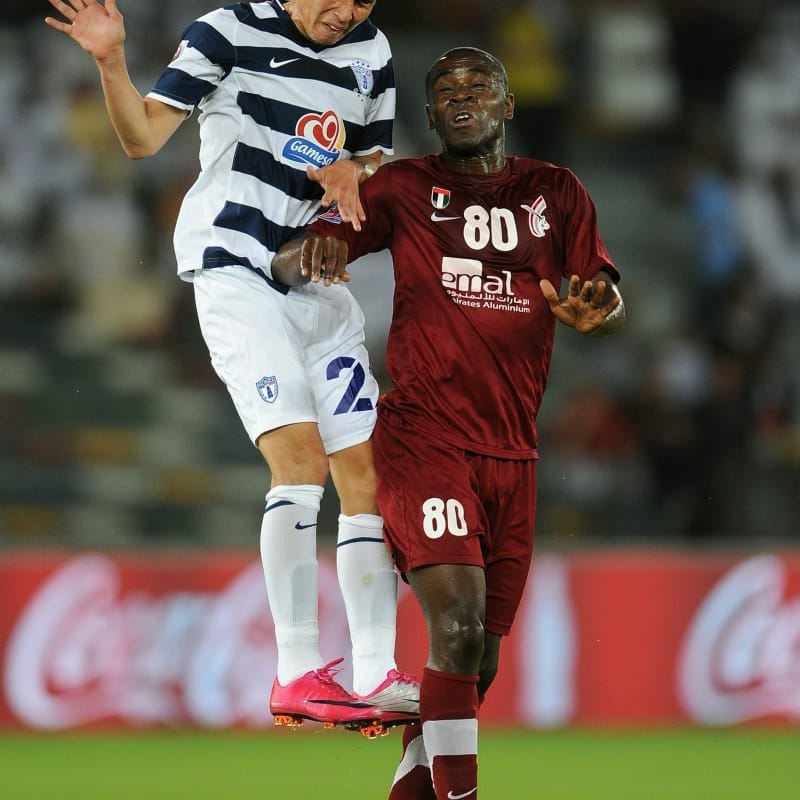 Leobardo Lopez of Club de Futbol Pachuca duels for a high ball with Hugo of Al Wahda