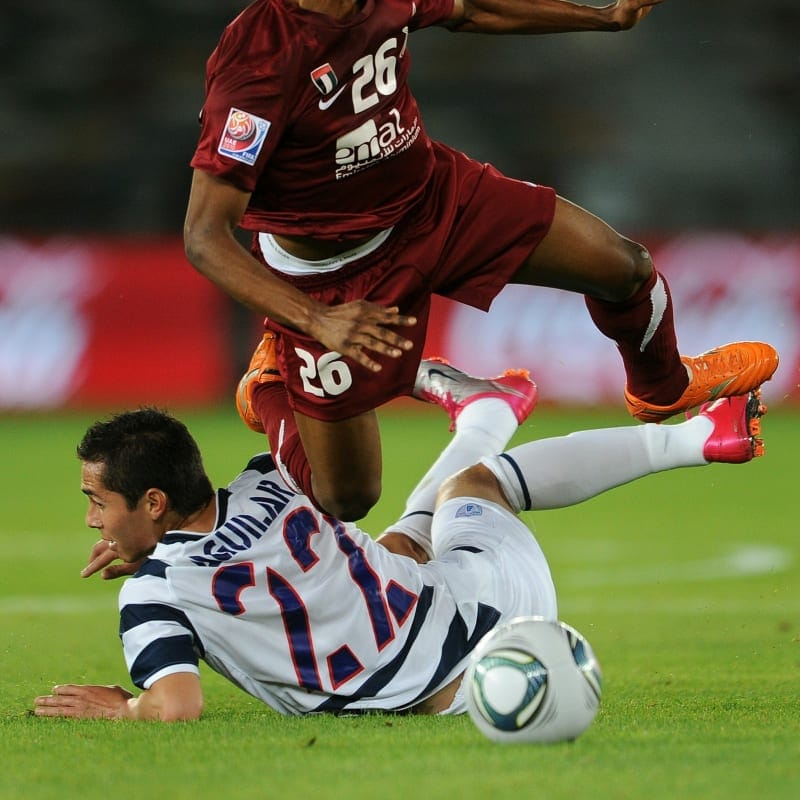 Mahmoud al Hammadi of Al-Wahda Sports Club is fouled by Paul Aguilar of Pachuca