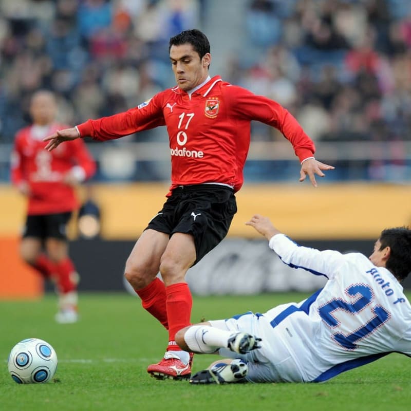 Al Ahly's Ahmed Hassan fights for the ball with Pachuca's Fausto Pinto