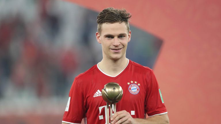 Joshua Kimmich of FC Bayern Muenchen poses with the FIFA Club World Cup Qatar 2020 adidas bronze ball trophy