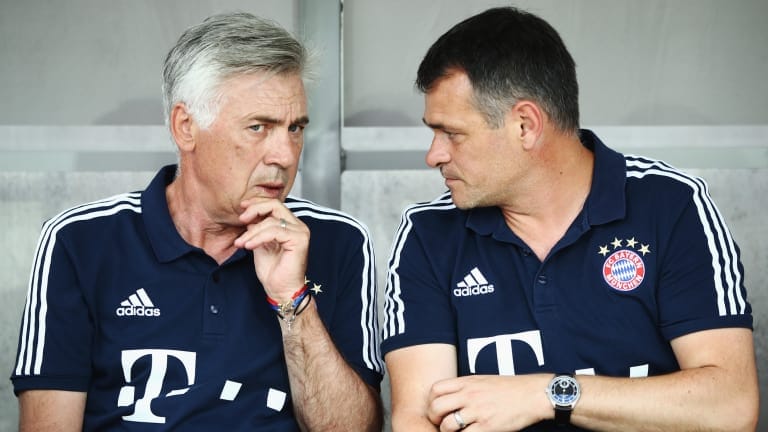 Head coach Carlo Ancelotti and assistant coach Willy Sagnol of Muenchen chat