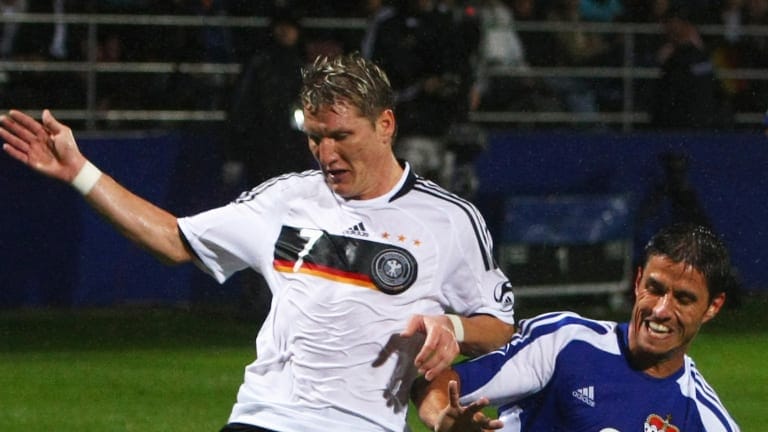 Martin Stocklasa (R) of Liechtenstein battles for the ball with Bastian Schweinsteiger (L) of Germany