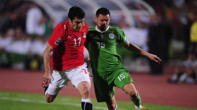 Ahmed Hassan of Egypt challenges Karim Ky Ziani of Algeria