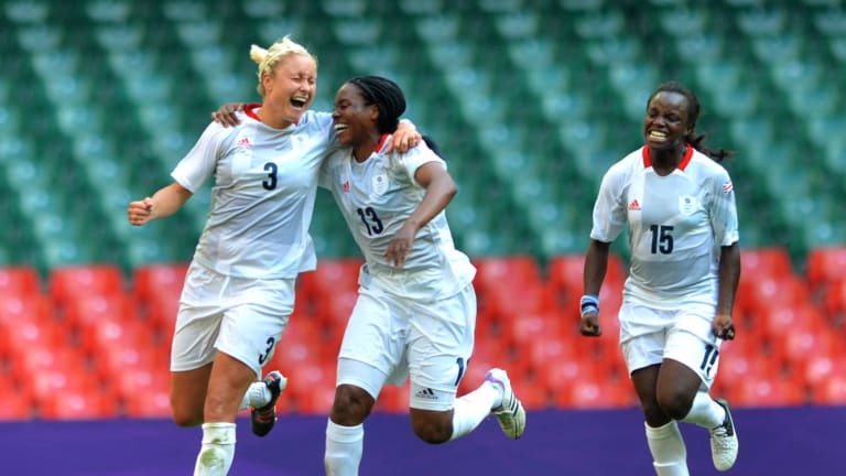 (L to R) Stephanie Houghton, Ifeoma Dieke and Eniola aluko of Great Britain celebrate scoring during the preliminary round Group E match of women s football between Great Britain and New Zealand in Cardiff, Great Britain, July 25. 2012. Great Britain won the match 1-0.