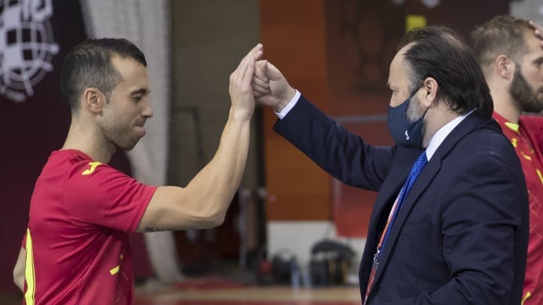 Spain futsal coach Fede Vidal congratulates a player during the past friendly match against Brazil