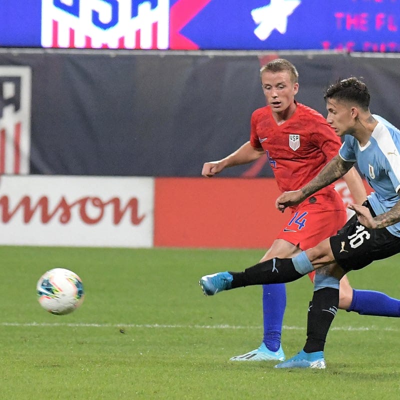 Uruguay winger Brian Rodriguez (16) passes the ball ahead of Uruguay defender Lucas Torreira (14)