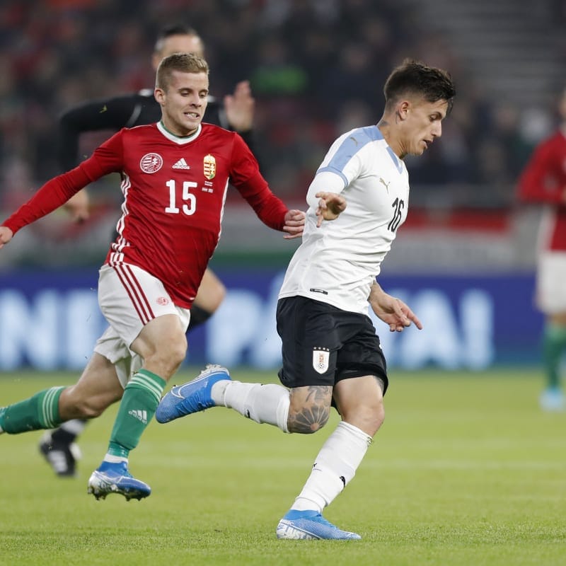 Brian Rodriguez of Uruguay runs with the ball under pressure from Istvan Kovacs of Hungary