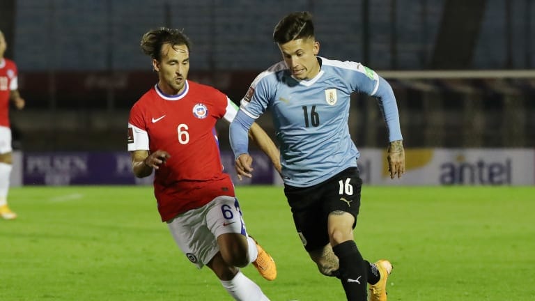Brian Rodriguez of Uruguay fights for the ball with José Pedro Fuenzalida of Chile