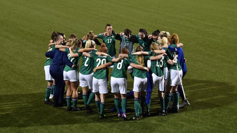 Northern Ireland players huddle on pitch, celebrating victory in the UEFA Women's Euro 2022 Play-off match between Northern Ireland and Ukraine at Seaview on April 13, 2021 in Belfast, Northern Ireland.