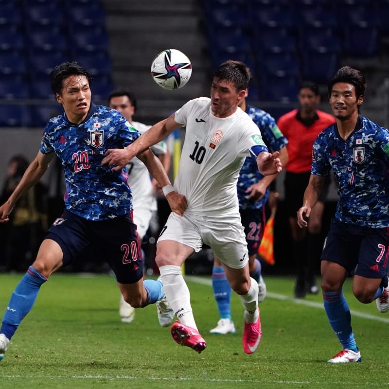 Mirlan Murzaev of Kyrgyz Republic and Shinnosuke Nakatani of Japan compete for the ball 