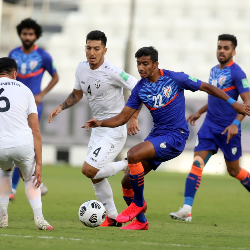 Muhammed Ashique Kuruniyan of India dribbles against Haroon Amiri of Afghanistan in FIFA World Cup Qatar 2022 qualifying