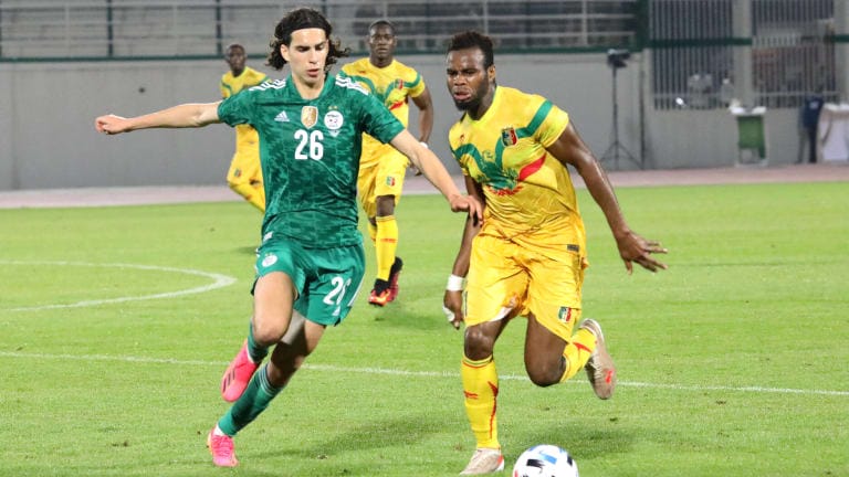 Ramiz Zerrouki (L) of Algeria in action against Mali