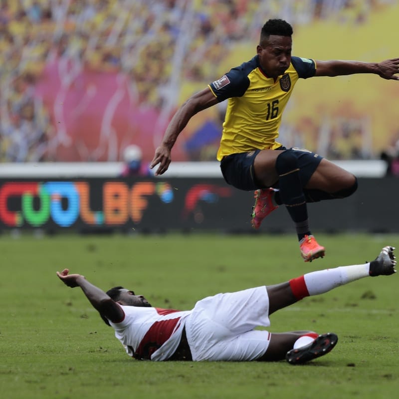 Jose Carbali of Ecuador fights for the ball with Christian Ramos of Peru