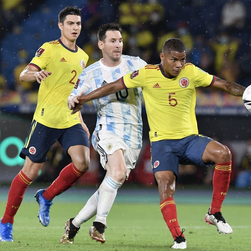 Wilmar Barrios of Colombia fights for the ball with Lionel Messi of Argentina