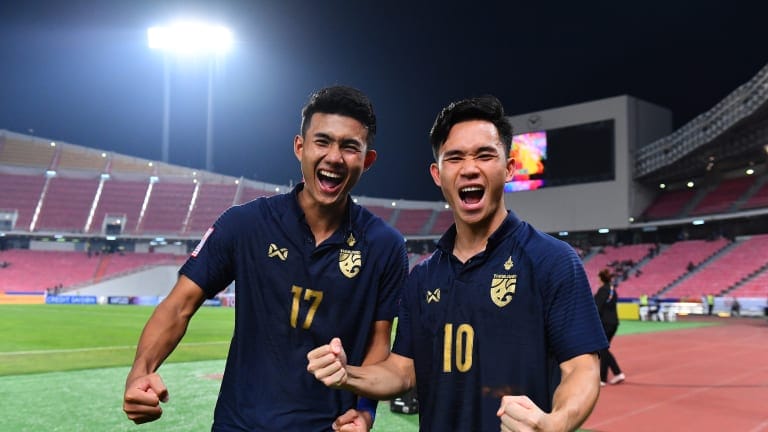 Supachok Sarachart (#10) and Suphanat Mueanta (#17) of Thailand celebrate victory over Bahrain