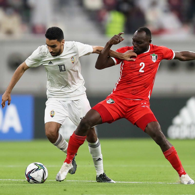 Alsanousi Ammar of Libya (L) is challenged by Abuaagla Abdalla of Sudan during the FIFA Arab Cup Qatar 2021 Qualifiers match between Libya and Sudan at Al Wakrah Stadium on June 19, 2021 in Doha, Qatar.&nbsp;