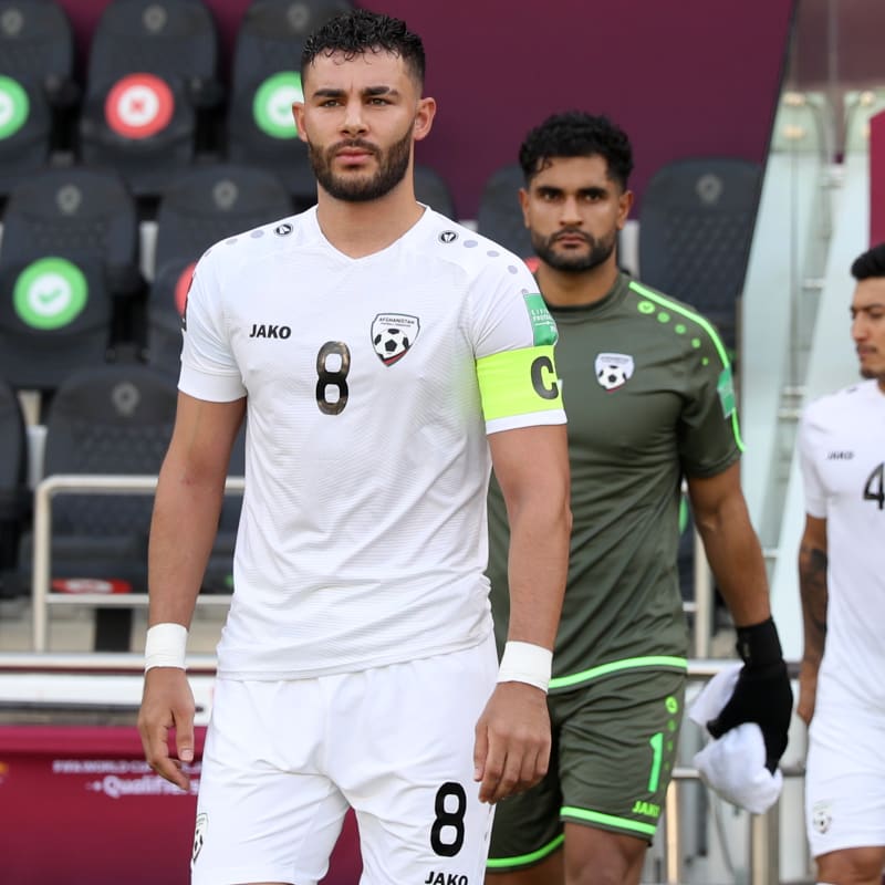 Afghanistan captain Farshad Noor walks out onto the pitch
