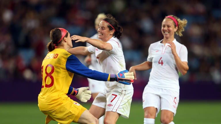 Rhian Wilkinson of Canada celebrates with Erin McLeod of Canada after the Women's Football Quarter Final match between Great Britain and Canada, on Day 7 of the London 2012 Olympic Games at City of Coventry Stadium on August 3, 2012 in Coventry, England.