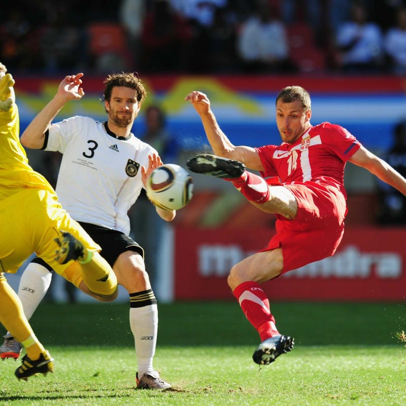 Milan Jovanovic of Serbia scores the first goal past goalkeeper Manuel Neuer (L) and Arne Friedrich of Germany