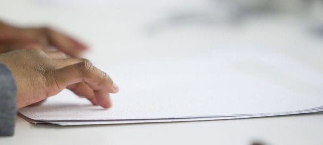 Emmanuel Elisha Ford, using paper printed in the Braille alphabet, speaks at the launch of the preparatory process of the High-level meeting of the General Assembly on disability and development. (2012)