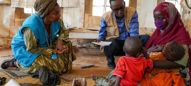 Rania Dagash, UNICEF Deputy Regional Director for Eastern and Southern Africa, (left) meets with a mother and her twins, who are suffering from malnutrition, at a health centre in Dollow, Somalia.