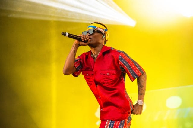 wizkid-performing-on-stage-dressed-in-red