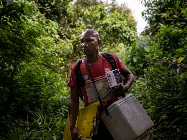 A nurse transports vaccines to remote villages on the banks of the Congo River in the Democratic Republic of the Congo. A nurse transports vaccines to remote villages on the banks of the Congo River in the Democratic Republic of the Congo.