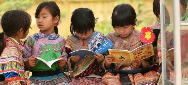 Girls from an indigenous community read outdoors at Ban Pho Primary School in Bac Han District in remote Lao Cai Province, Viet Nam. Girls from an indigenous community read outdoors at Ban Pho Primary School in Bac Han District in remote Lao Cai Province, Viet Nam.