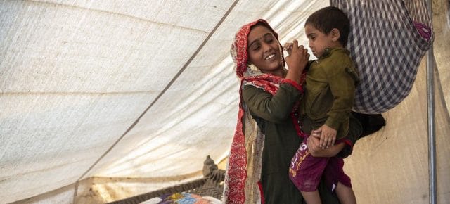 On 3 November 2022 in Jacobabad, Sindh province, Pakistan, 15-year-old Sugra, whose home was destroyed in recent floods, holds her brother, Fayaz. On 3 November 2022 in Jacobabad, Sindh province, Pakistan, 15-year-old Sugra, whose home was destroyed in recent floods, holds her brother, Fayaz.