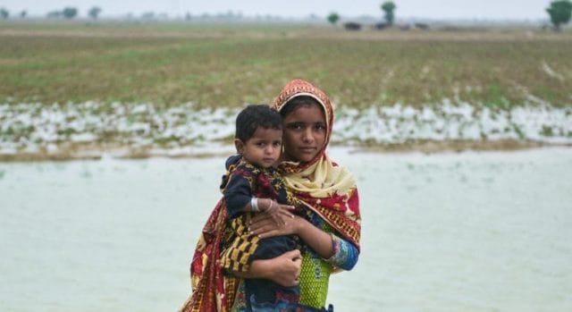 On 18 August 2022, children displaced by torrential rains and floods pose for a photograph in Union Council Chattar, district Naseerabad, Balochistan, Pakistan.