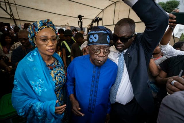 Presidential candidate Bola Tinubu of the All Progressives Congress, center, accompanied by his wife, Oluremi Tinubu, left, leaves after casting his vote, in the presidential elections in Lagos, Nigeria, Saturday, February 25, 2023.