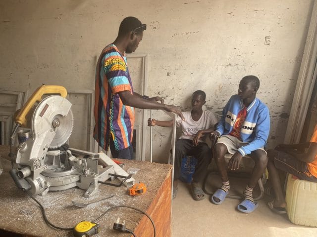 Amadou Jobe, a returning migrant, trains apprentices in a workshop in Banjul, The Gambia. Amadou Jobe, a returning migrant, trains apprentices in a workshop in Banjul, The Gambia.