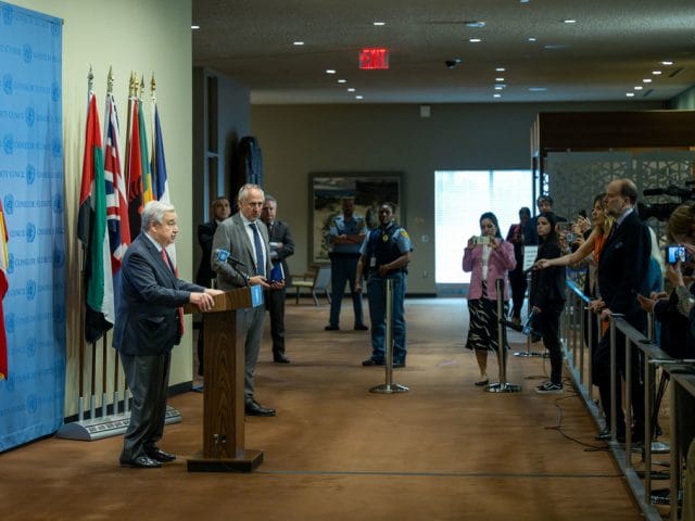Secretary-General António Guterres (at podium) briefs reporters about the destruction in the Kakhovka hydroelectric power plant dam in Ukraine.