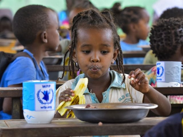 Children eat food provided by one of WFP's home grown school feeding programmes in South Omo, Ethiopia. Children eat food provided by one of WFP's home grown school feeding programmes in South Omo, Ethiopia.