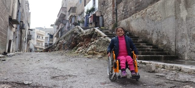 Eight-year-old Hanaa, who was paralysed by an exploding bomb and lost the use of her legs, sits in her wheelchair near her home in East Aleppo City, Syria. (file) Eight-year-old Hanaa, who was paralysed by an exploding bomb and lost the use of her legs, sits in her wheelchair near her home in East Aleppo City, Syria. (file)